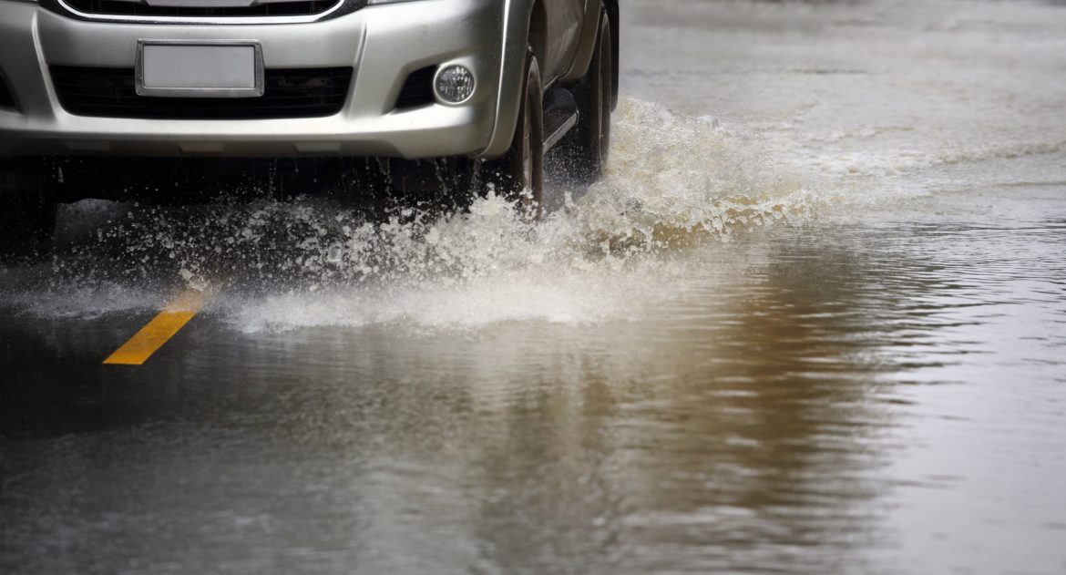 Car driving through flood waters